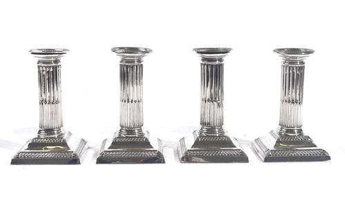 A SET OF FOUR CANDLESTICKS (4)