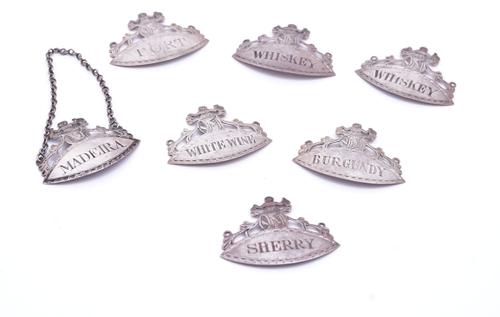 SEVEN IRISH SILVER OVAL DECANTER LABELS (7)