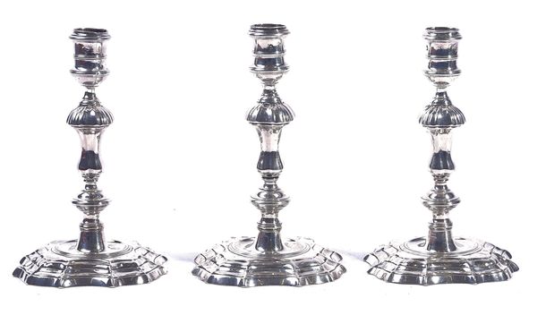 A PAIR OF AND ONE FURTHER GEORGE II SILVER CANDLESTICKS (3)