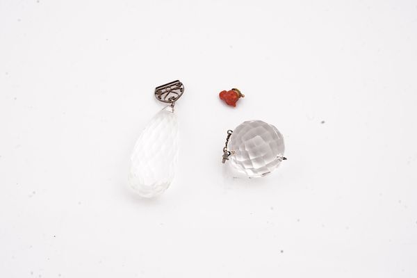 TWO ROCK CRYSTAL PENDANT DROPS AND A CARVED CORAL BULL'S HEAD FITTING (3)
