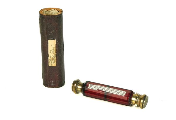 A VICTORIAN CUT RUBY GLASS AND SILVER-GILT TWIN ENDED SCENT BOTTLE