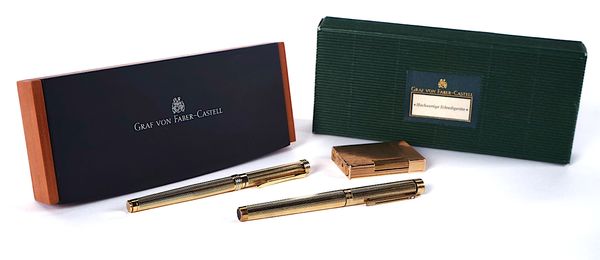 A ST DUPONT GOLD PLATED LIGHTER AND THREE PENS (4)