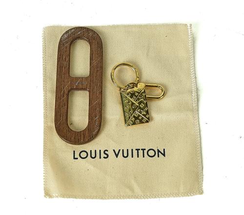 A LOUIS VUITTON GILT METAL KEY CHAIN (2)
