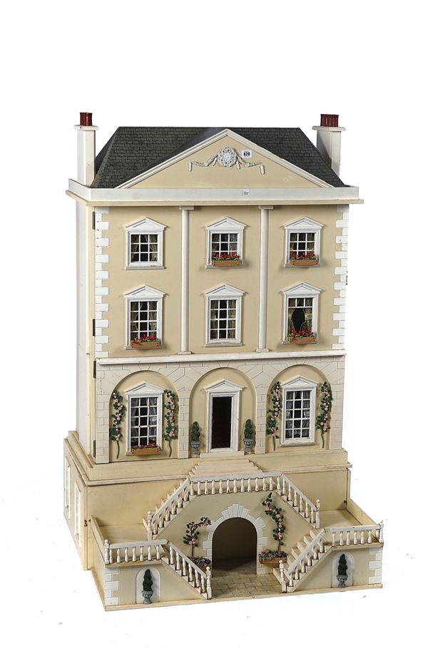 A LARGE CREAM PAINTED WOODEN DOLL'S HOUSE