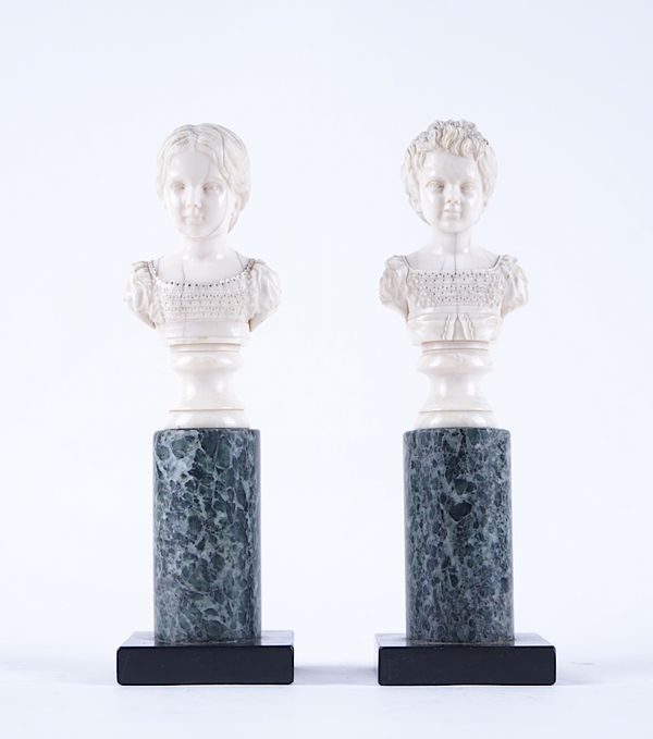 A PAIR OF FRENCH CARVED IVORY BUSTS OF CHILDREN (2)