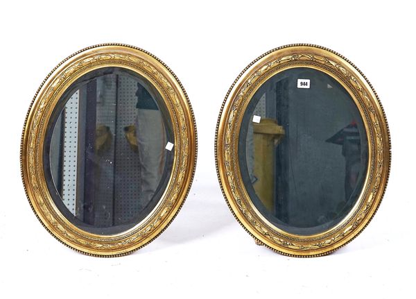 A PAIR OF VICTORIAN GILT FRAMED OVAL MIRRORS (2)