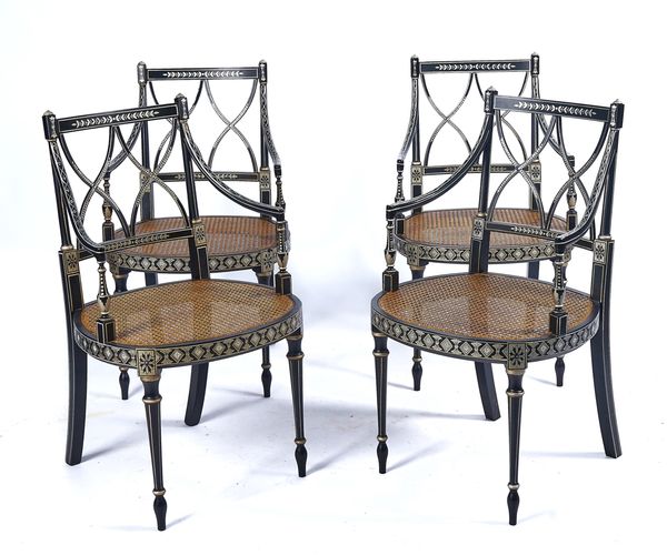 A SET OF FOUR FRENCH EMPIRE STYLE EBONISED AND WHITE PAINTED OPEN ARMCHAIRS (4)