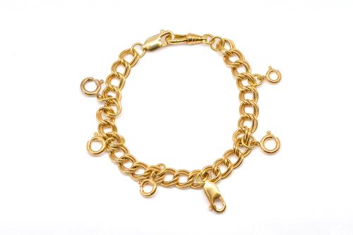 A GOLD TWIN CURB LINK BRACELET WITH EIGHT VARIOUS GOLD CLASPS