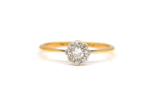 A GOLD AND DIAMOND NINE STONE CLUSTER RING