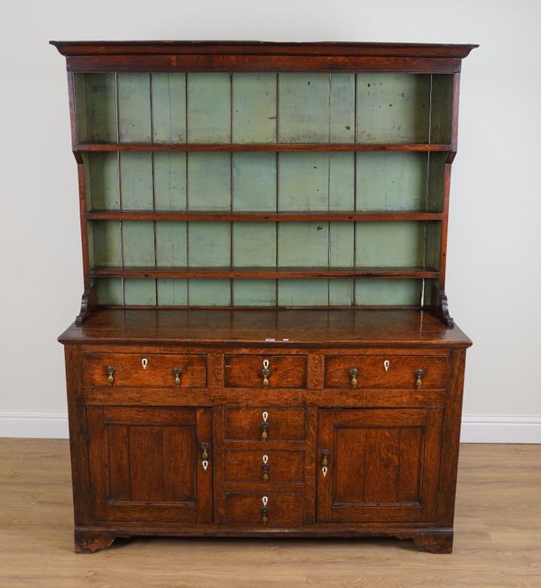 AN 18TH CENTURY OAK DRESSER WITH ENCLOSED THREE TIER PLATE RACK