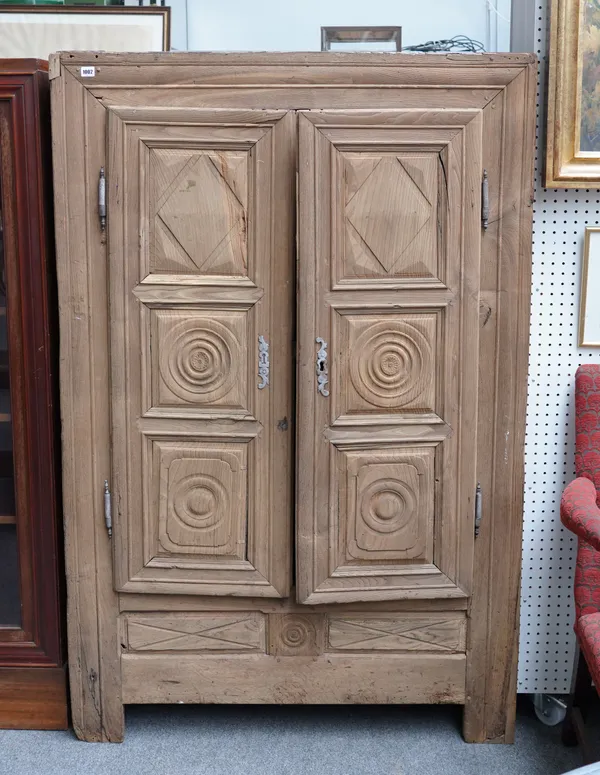 AN 18TH CENTURY CONTINENTAL STRIPPED OAK TWO DOOR ARMOIRE