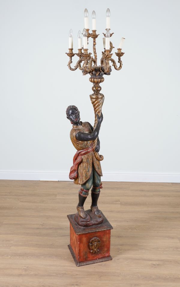 A 20TH CENTURY POLYCHROME PAINTED CANDELABRA ON MOOR FIGURAL SUPPORT