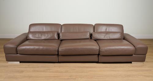 ROCHE BOBOIS; A BROWN LEATHER UPHOLSTERED TRIPLE SECTION SOFA