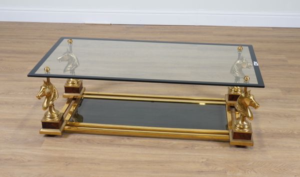 A 20TH CENTURY GLASS TOPPED RECTANGULAR COFFEE TABLE WITH CORNER HORSE HEAD FINIAL SUPPORTS