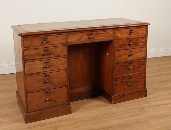 A VICTORIAN MAHOGANY ELEVEN DRAWER WRITING DESK