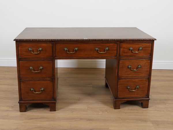 AN EARLY 19TH CENTURY MAHOGANY SEVEN DRAWER WRITING DESK