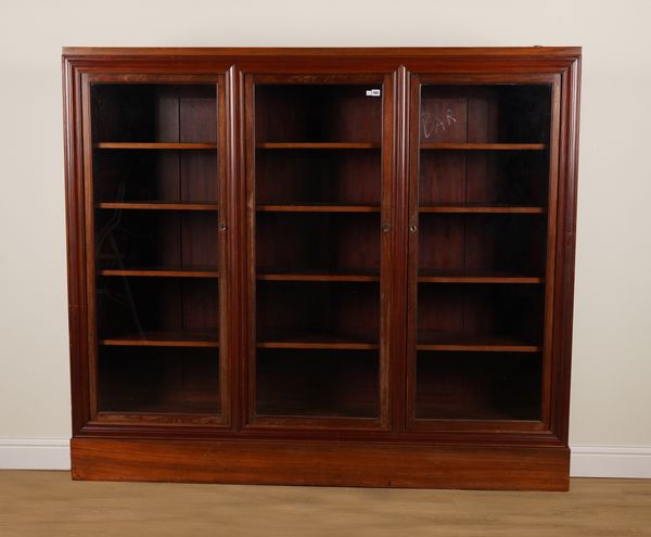 A LATE 19TH CENTURY MAHOGANY FRAMED GLAZED THREE DOOR BOOKCASE