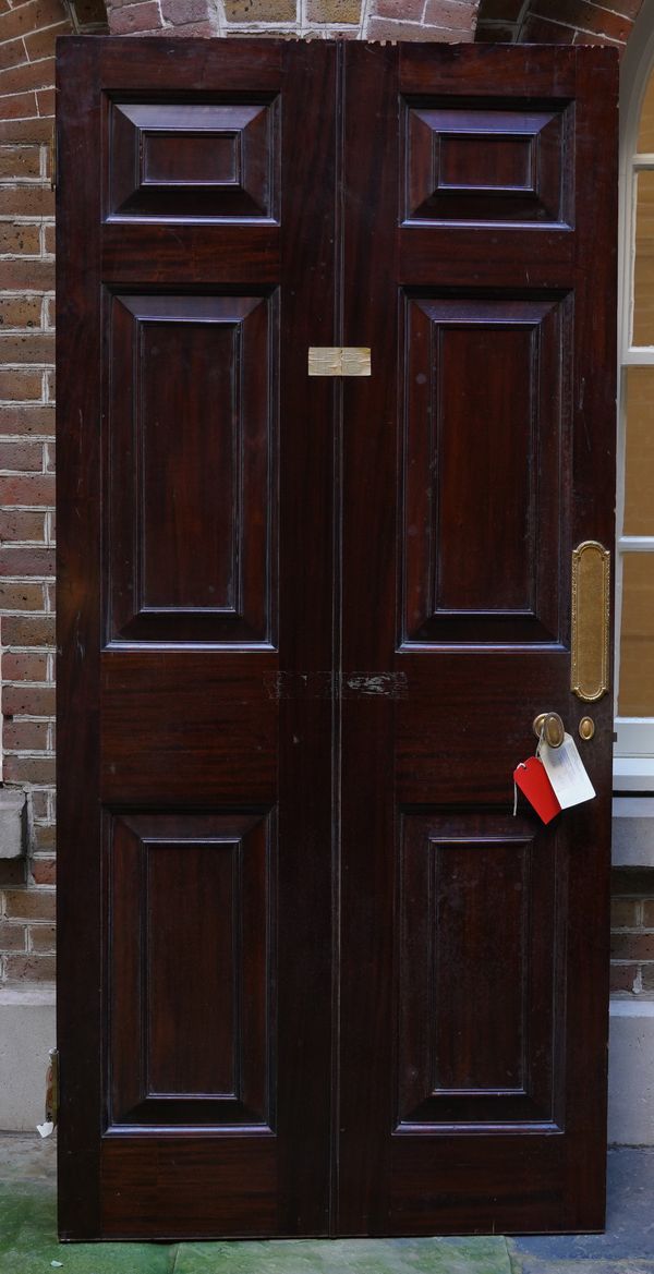 A MAHOGANY GILT METAL MOUNTED PANELLED AND FIELDED DOOR