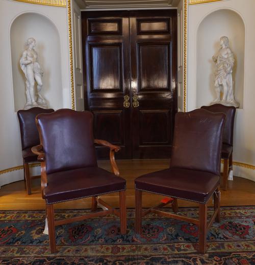 A SET OF FOUR MID-18TH CENTURY DESIGN STUDDED ROUGE LEATHER UPHOLSTERED MAHOGANY FRAMED HUMP BACK DINING CHAIRS (4)