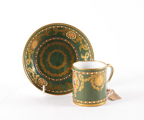 A SEVRES `JEWELLED' GREEN-GROUND CABINET CUP AND SAUCER