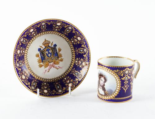 A SEVRES STYLE BLUE-GROUND `JEWELLED' CABINET CUP AND SAUCER (2)