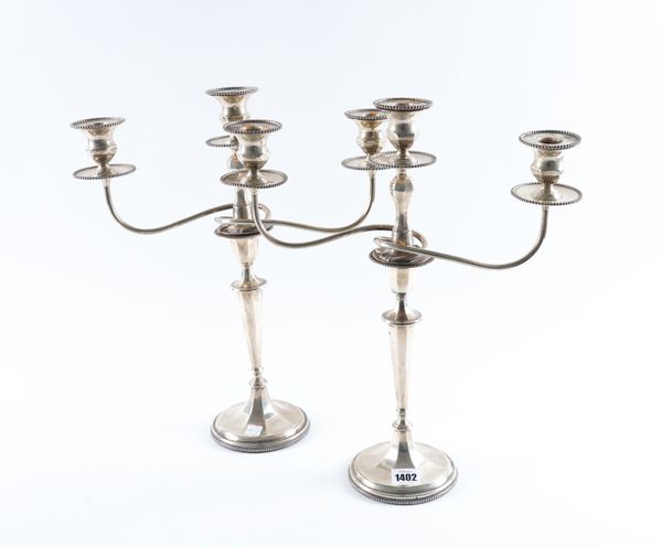 A PAIR OF SILVER TABLE CANDLESTICKS WITH ASSOCIATED SILVER THREE LIGHT CANDELABRA BRANCHES (2)