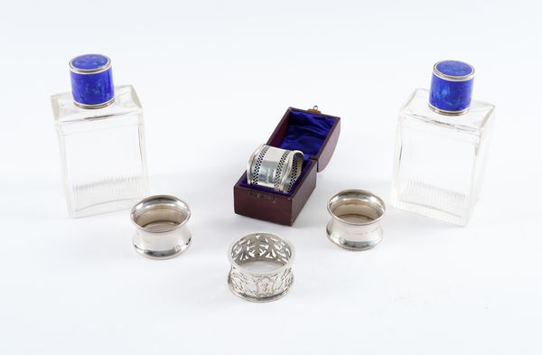 A PAIR OF SILVER NAPKIN RINGS, TWO FURTHER NAPKIN RINGS AND A PAIR OF FRENCH SCENT BOTTLES (6)