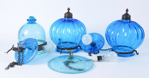 A PAIR OF BRASS MOUNTED BLUE GLASS ‘HUNDI’ PENDANT LAMPS AND ANOTHER WITH ENGRAVED DECORATION