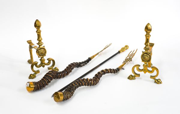 A SET OF BRASS MOUNTED IMPALA HORN TOASTING FORKS, BRASS FIRE DOGS AND A BRASS MOUNTED POKER (5)