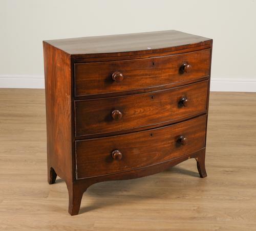 A REGENCY MAHOGANY BOWFRONT THREE DRAWER CHEST OF DRAWERS