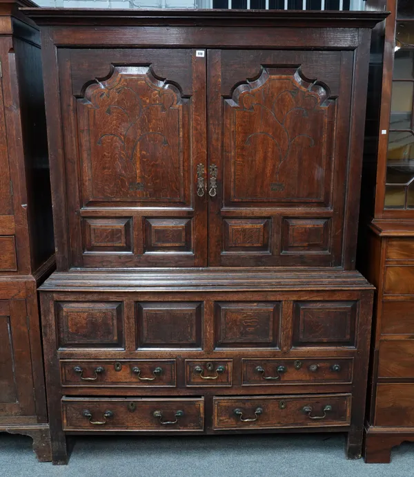 A 17TH CENTURY OAK RAISED PANELLED TWO DOOR LIVERY CUPBOARD