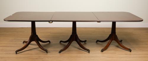 A REGENCY STYLE MAHOGANY TRIPLE PEDESTAL MAHOGANY EXTENDING DINING TABLE