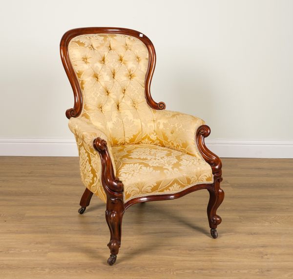 A VICTORIAN CARVED MAHOGANY FRAMED SPOON BACK ARMCHAIR