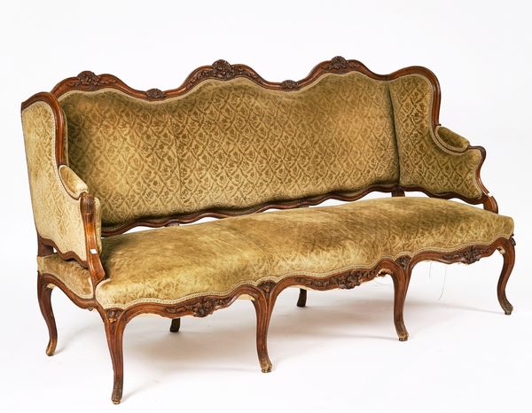 A LOUIS XV CARVED WALNUT FRAMED WINGBACK SOFA