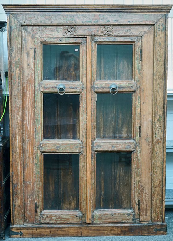 AN INDIAN FLOOR STANDING GLAZED TWO DOOR CABINET