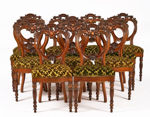 A SET OF TWELVE VICTORIAN CARVED MAHOGANY DINING CHAIRS