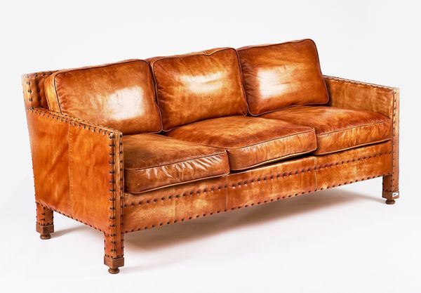 A MID-20TH CENTURY THREE-SEAT STUDDED BROWN LEATHER UPHOLSTERED SQUARE BACK SOFA