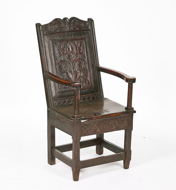 A CHARLES II OAK PANEL-BACK OPEN ARMCHAIR