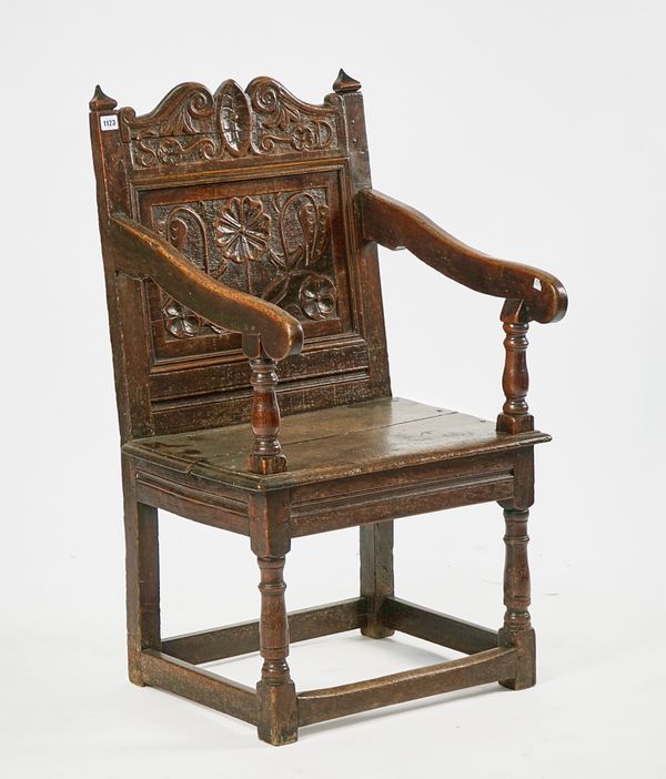 A CHARLES II JOINED OAK OPEN ARMCHAIR