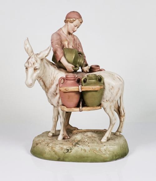 A ROYAL DUX GROUP OF A PEASANT BOY STANDING BESIDE A DONKEY