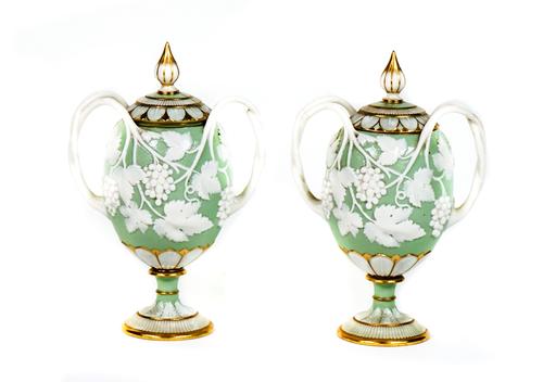 A pair of Minton white and celadon ground two-handled vases and covers