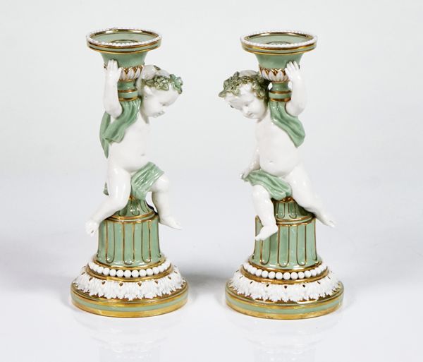 A pair of Minton white and celadon glazed porcelain candlesticks