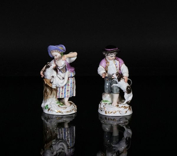 A pair of Meissen figures of children