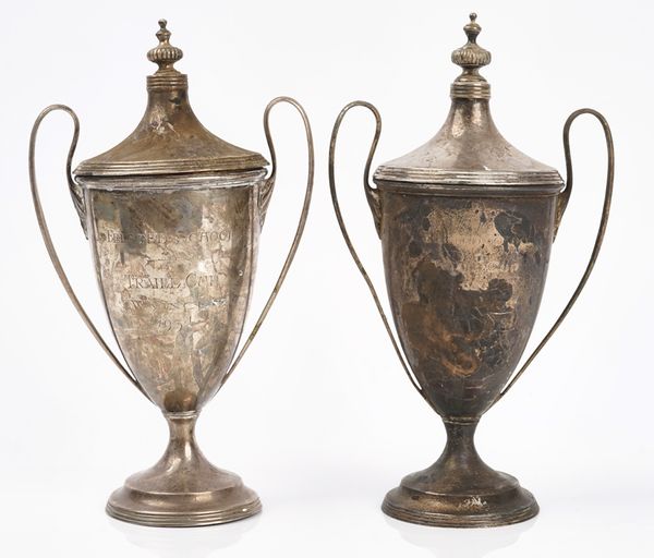 Two similar silver twin handled cups and covers