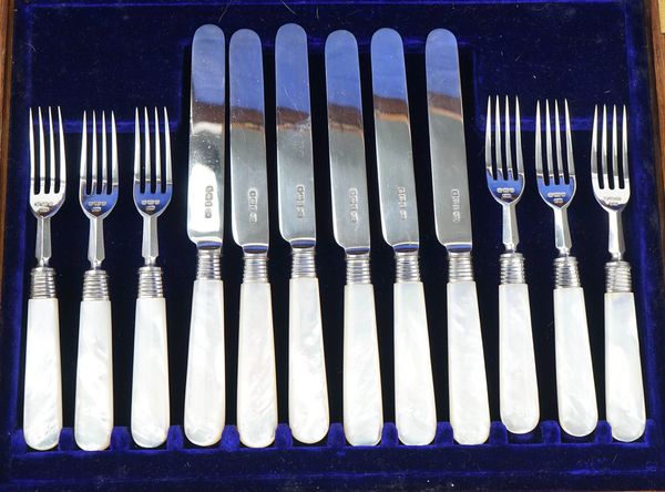 A set of six pairs of silver dessert or fruit knives and forks
