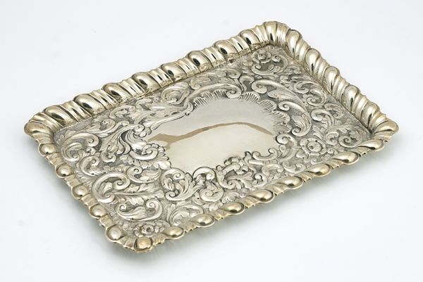 A silver dressing table tray