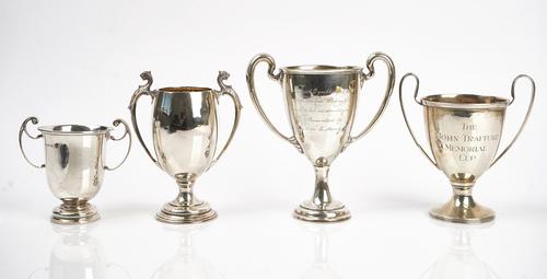 A silver twin handled trophy cup and four further silver twin handled trophy cups (5)
