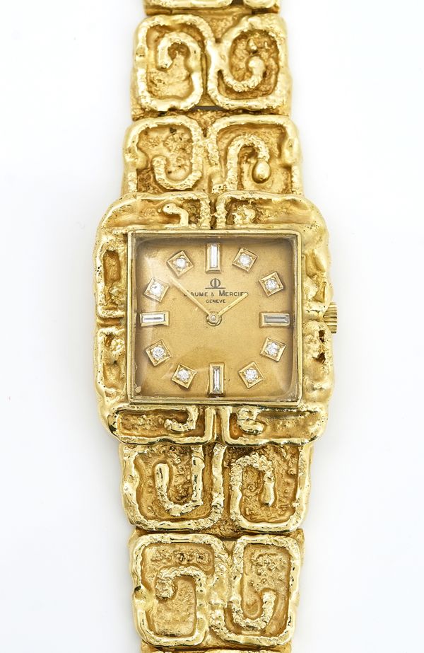 A gold and diamond dress bracelet wristwatch