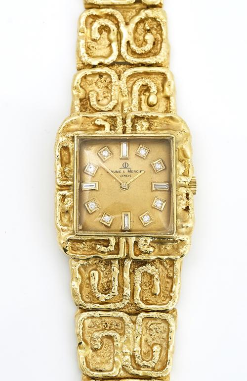 A gold and diamond dress bracelet wristwatch