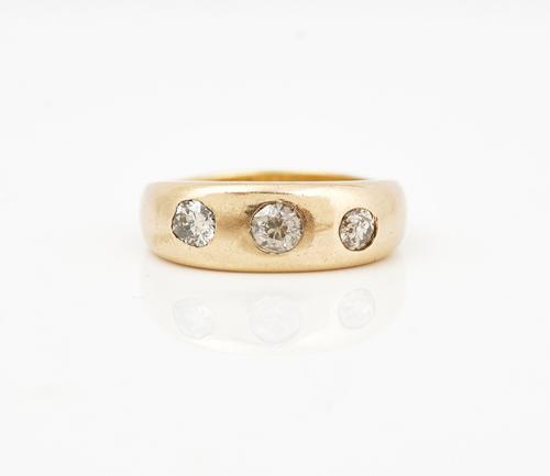 A gold and diamond set three stone ring